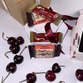 loose cherries scattered amongst 2 x Cherry Soft Nougat, 2 x Cherry & Macadamia Nougat, 