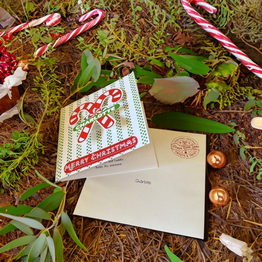 candy cane card and envelope lying on ground
