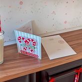 candy cane card and envelope on kitchen bench