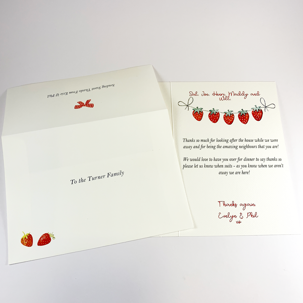 This image shows the envelope front with the part of the back you seal. The front has the recipients name and two red straberries in bottom left corner. On the back is a red bow and a short message from sender/giver. It also shows strawberry notepaper with a lovely thank you written on it.