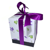 lavender and lime printed product box tied with purple ribbon against a white background