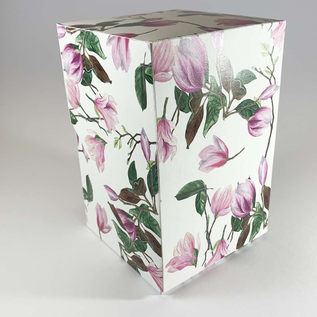 Pink magnolia blossom product box showing glossy print texture - no ribbon