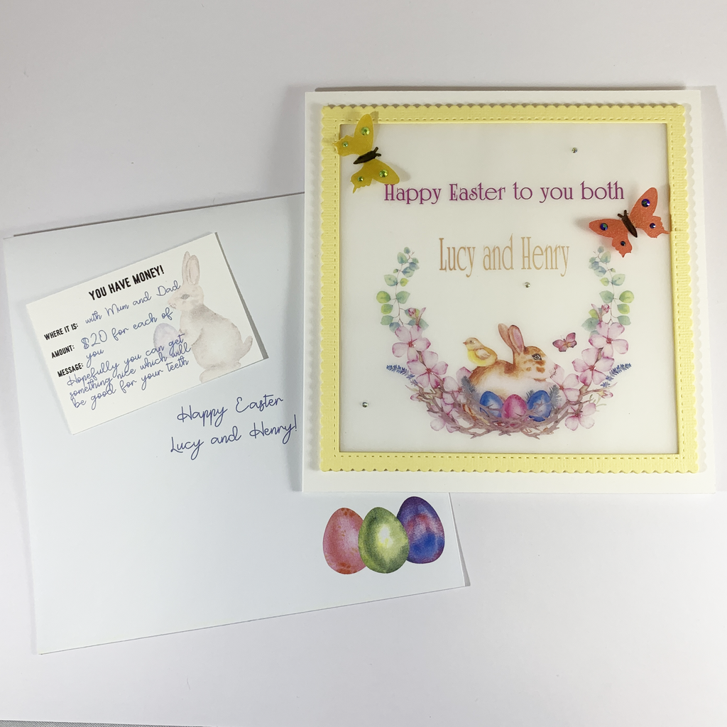 This is an image of the matching envelope, a gift card and the card. The envelope has three coloured Easter Eggs in the bottom right hand corner.  It also has a example message written on it for the recipient. The gift tag is white and is a &quot;You Have Money&quot; tag containing the information of where the money is, how much and a message.