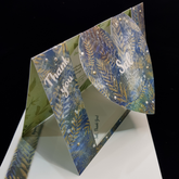 A beautiful heart swing card stands upright on a matching envelope. with the words "thank you" on the left, the name Sal sits centrally on the swinging heart and another sentiment "so very much" sits on the right. Delicate golden stems of foliage overlay over the top of a mottled blue toned background. Pops of pearl colours ranging from white, antique gold and blues have been selectively hand applied.