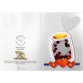Card featuring a jar of hearts on the front and and heart cutout in the top right hand corner on the outstside. The jar is created as a raised shaker window containing irridescent pearl and red hearts of various sizes. On the mid to bottom left back of greeting card featuring Angelic Thoughts logo, web address, mother and infant koala with the words made with love in Australia and a choking hazard warning. FSC logo representing Responsible Forestry Certification.